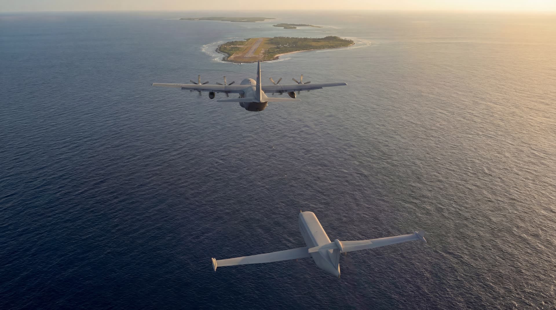 C-130 towing a cargo glider over a Pacific island approaching an atoll